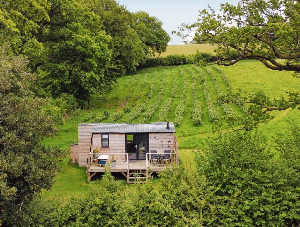 Image showcasing Off-Grid Luxury in a Shepherd's Hut | Tiny Home with Hot Tub Retreat ...